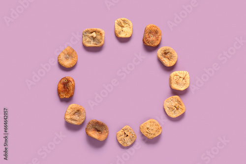 Frame made of sweet dried figs on purple background