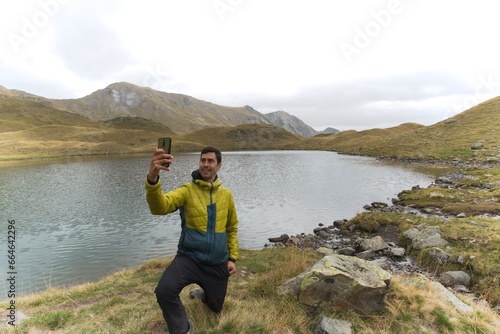 man taking a selfie in a mountain lake. in the French Pyrenees