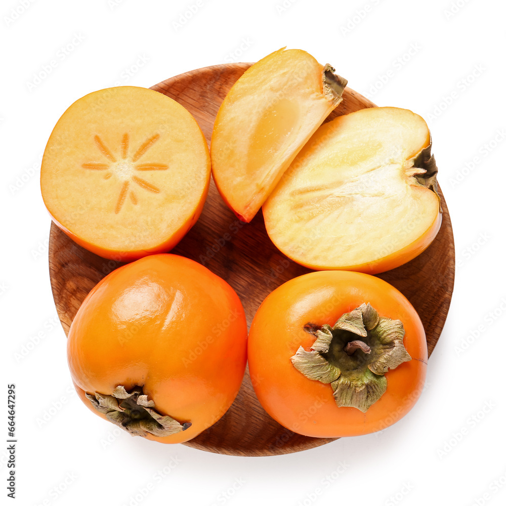 Wooden plate with sweet ripe persimmons on white background