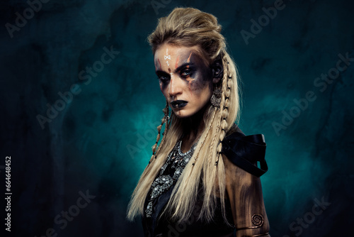 Photo of dangerous powerful shield maiden tribal queen demonic viking ready for fierce war over dark mist background