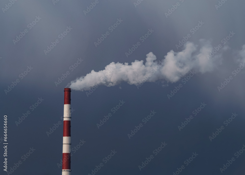 Heat and power plant with smoke pipes in snow storm on a cloudy autumn day. Thermal power industry. Place for your text. Heat and power plant with smoke pipes in snow storm on a cloudy autumn day. Thermal power industry. Place for your text.