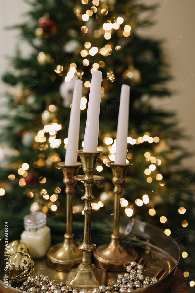 Christmas candles and ornaments over dark background with lights Christmas candles and ornaments over dark background with lights