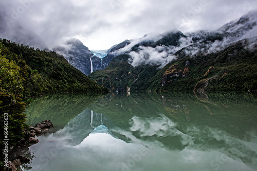 Hanging Glacier reflected in the Ventisquero Lagoon, with mist, Queulat National Park, Aysén, Chilean Patagonia photo