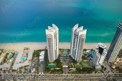 Sunny Isles Beach city with luxurious highrise hotels and condo buildings on Atlantic ocean shore. American tourism infrastructure in southern Florida