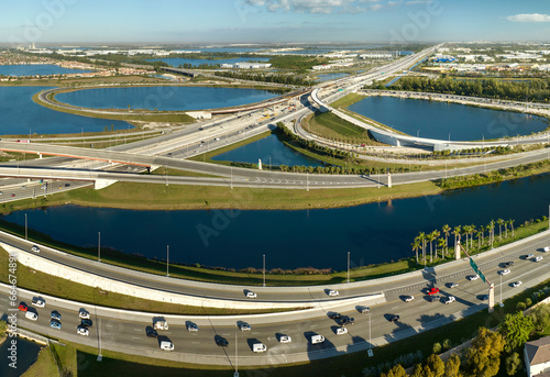 View from above of USA transportation infrastructure. Aerial view of american highway junction with fast driving vehicles in Miami, Florida