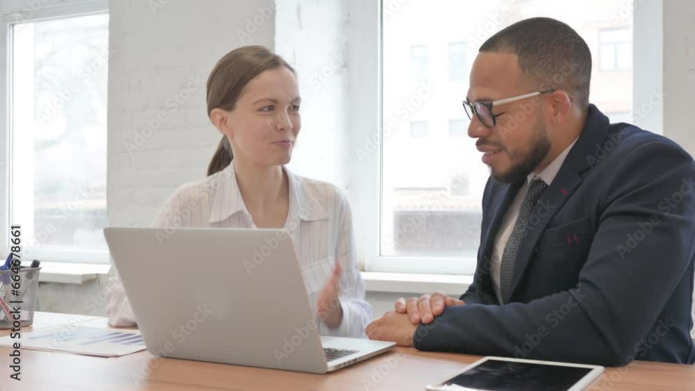 Mixed Race Business People Discussing Project on Laptop Mixed Race Business People Discussing Project on Laptop