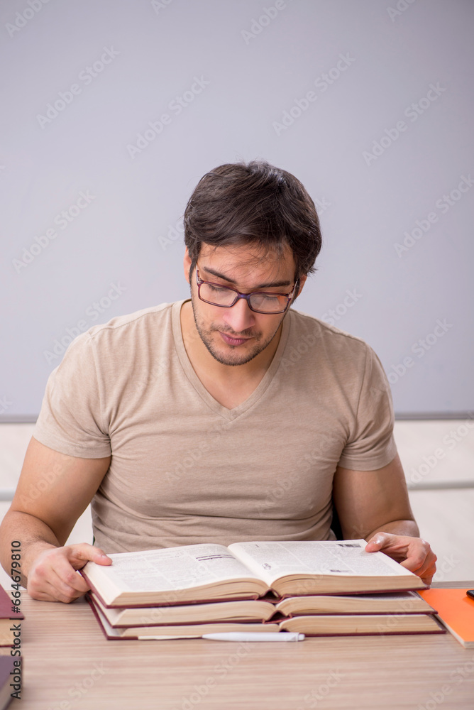 Young male student sitting in the classroom Young male student sitting in the classroom