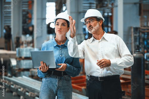 Obraz na plátně Factory manager or executive make visit metalwork manufacturing factory tour and inspect heavy steel industrial machinery showcase leadership quality as engineering inspection supervisor