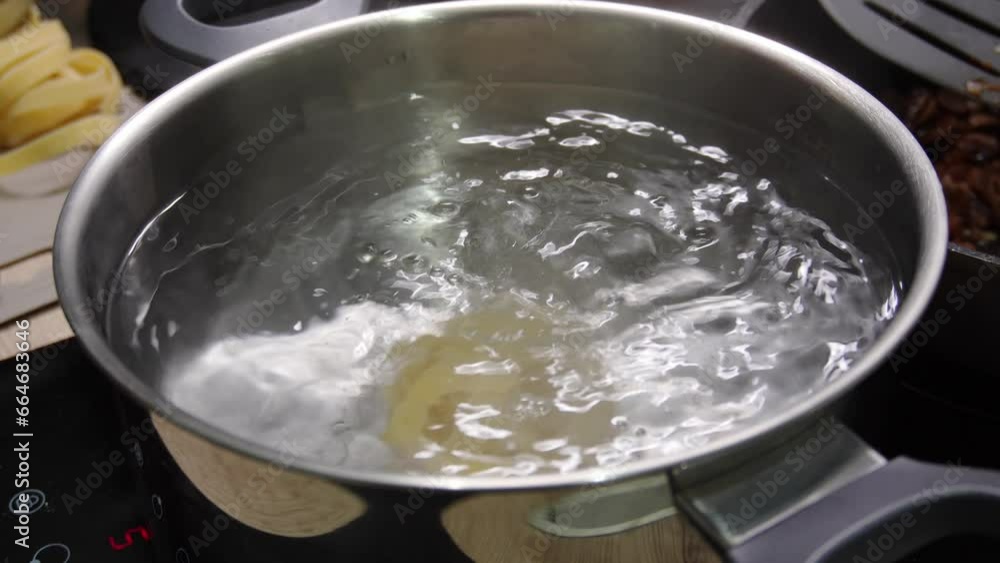 Cooking pasta. Preparing togliatelli. Put the yellow noodles in a pot of boiling water. High quality 4k footage Cooking pasta. Preparing togliatelli. Put the yellow noodles in a pot of boiling water. High quality 4k footage