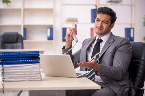 Young male employee working in the office