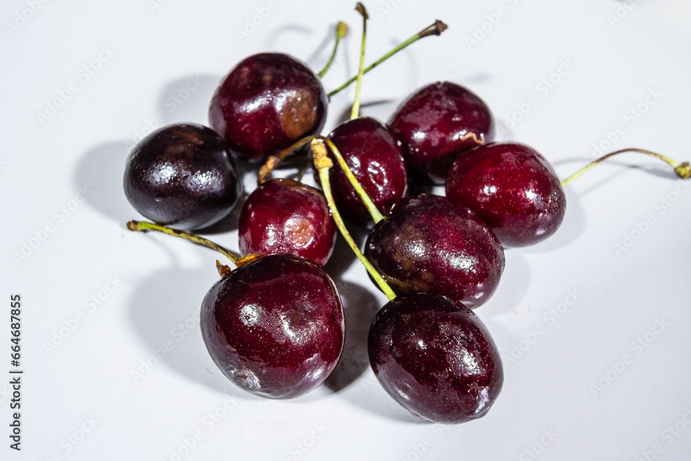 Selective blur on red cherries on a plate, in a studio shot. Cherries, also called prunus cerasus,is a berry also known as sour cherry. Selective blur on red cherries on a plate, in a studio shot. Cherries, also called prunus cerasus,is a berry also known as sour cherry.
