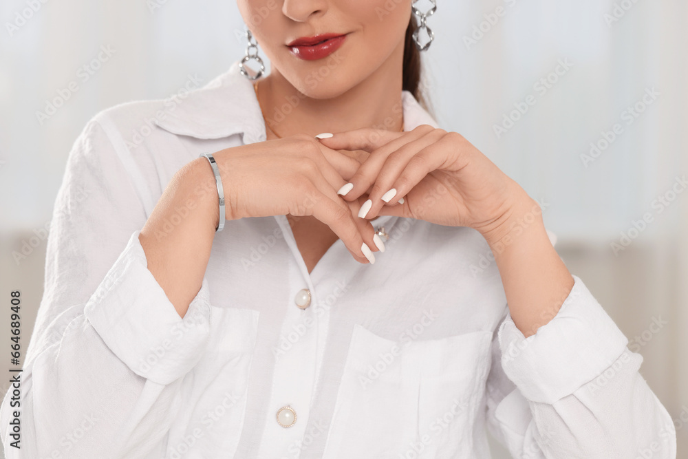 Beautiful woman with elegant jewelry indoors, closeup