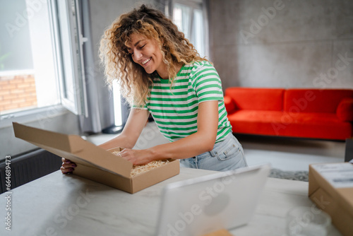 one happy woman open mail cardboard package box present at home © Miljan Živković