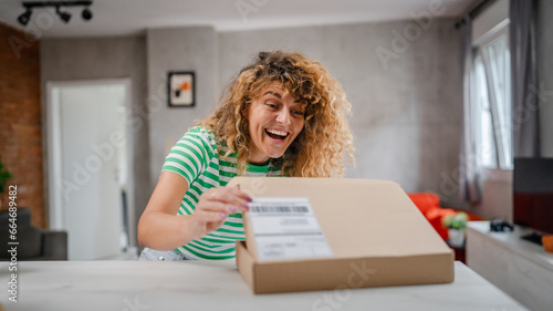one happy woman open mail cardboard package box present at home