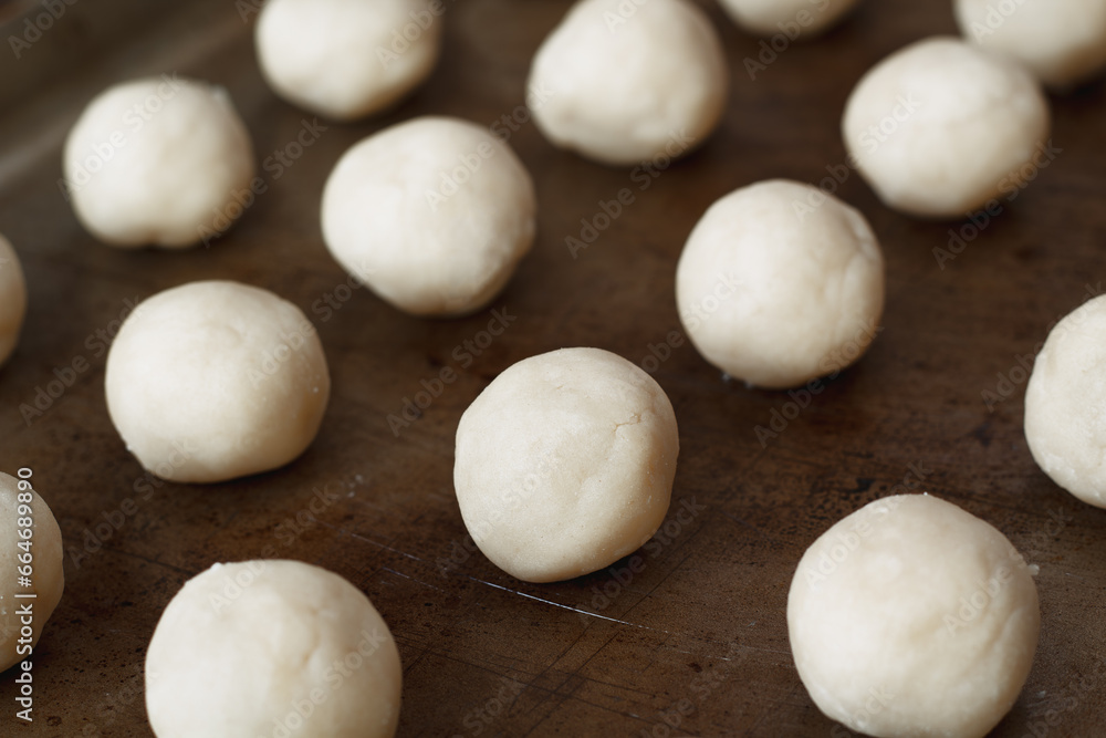 Ready to bake vanilla cookie dough balls on rustic baking sheet