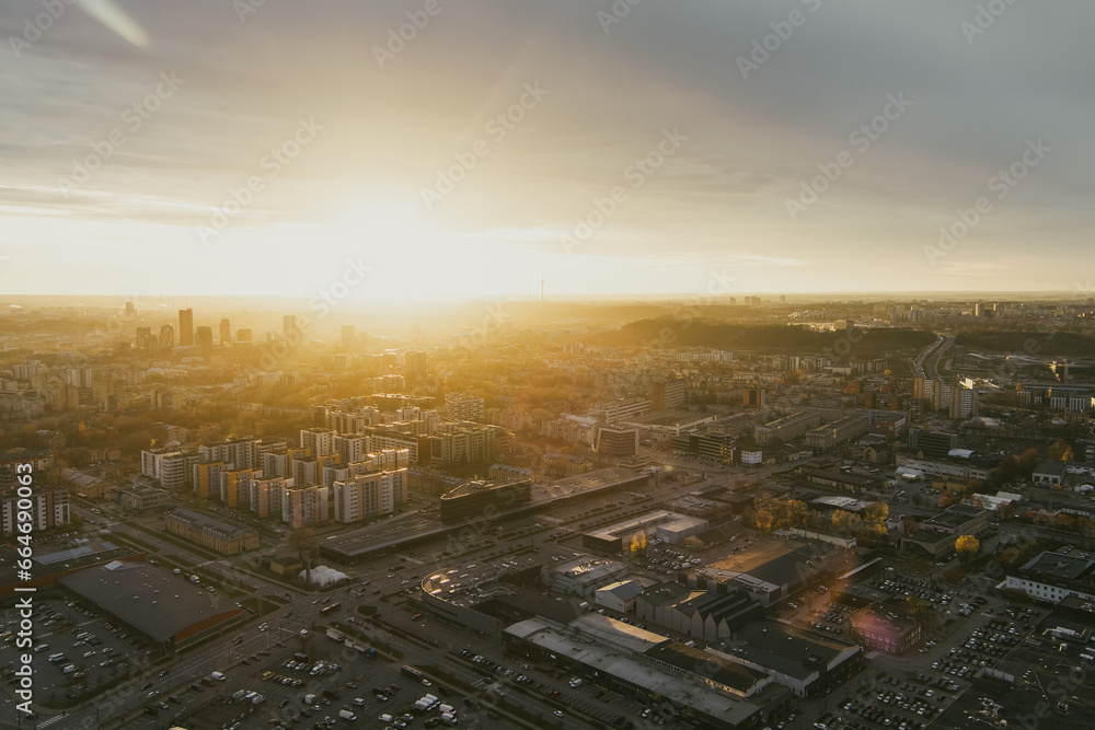 Fototapeta premium Scenic Vilnius city panorama in winter, Zirmunai district of a town. Aerial sunset view. Winter city scenery in Lithuania.