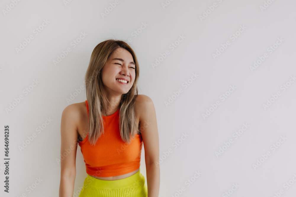 Laughing and cheerful asian woman dress in orange lemon isolated on white. Laughing and cheerful asian woman dress in orange lemon isolated on white.
