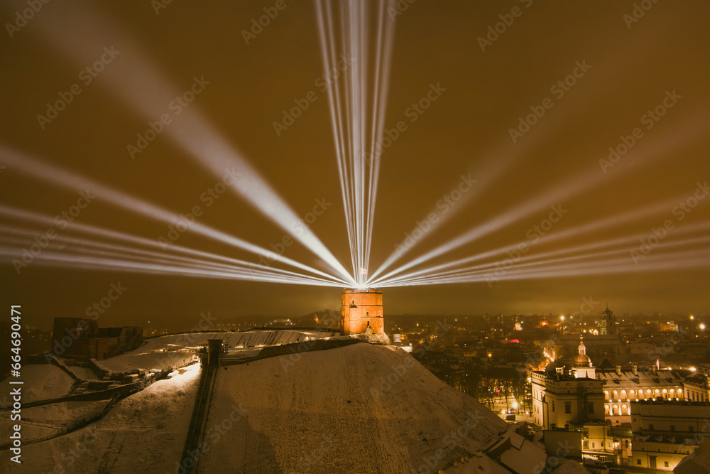 Obraz na płótnie Scenic aerial view of Gediminas tower in Vilnius Old Town beautifully illuminated for 700th birthday celebration. Main symbol of Lithuanian capital at night. w salonie