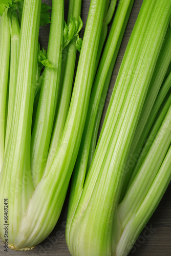 Fresh green celery stalks on wooden table, top view