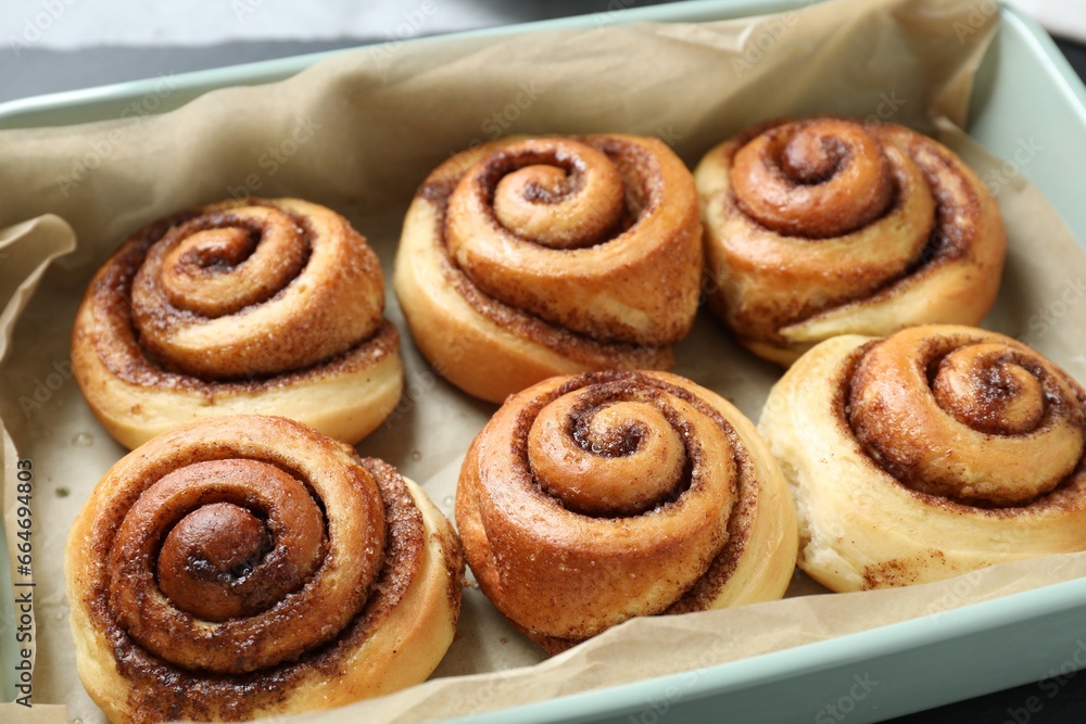 Baking dish with tasty cinnamon rolls on table, closeup Baking dish with tasty cinnamon rolls on table, closeup