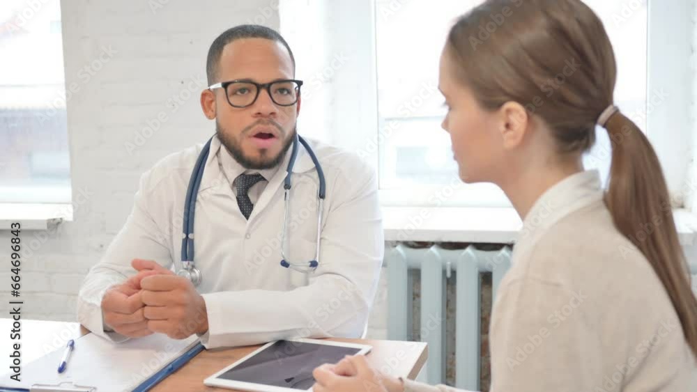 African Doctor Talking with Female Patient in Clinic African Doctor Talking with Female Patient in Clinic