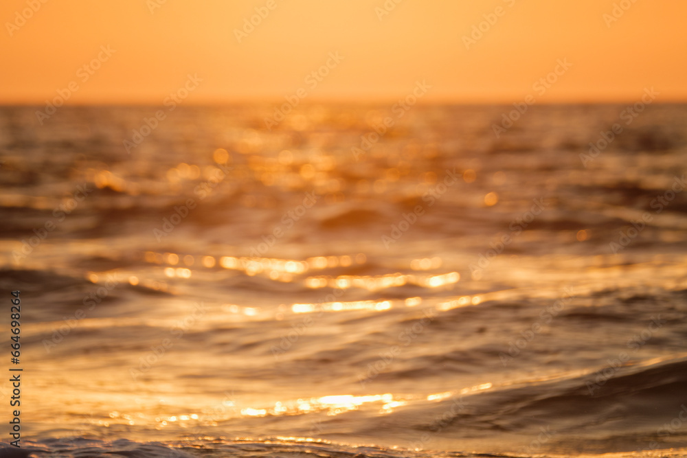 Fototapeta premium Ocean on sunset backlit with sun defocused blurred background