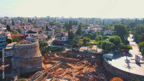 Enjoy a breathtaking view of Hidirlik Tower, an iconic symbol of Antalya's historical center, in this mesmerizing aerial stock video. The tower, with its ancient charm and stunning location photo