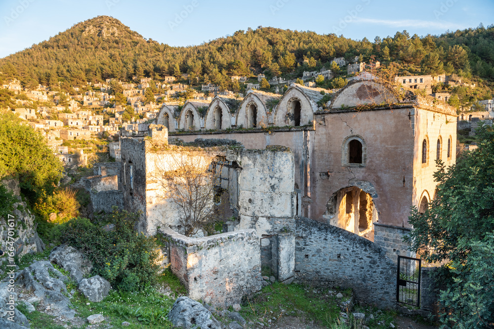 Fototapeta premium Ruined Taksiyarhis upper church of Kayakoy (Levissi) abandoned village near Fethiye in Mugla province of Turkey. The church dates from the 19th century. 