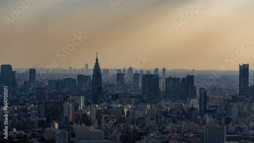 Tokyo Shinjuku area high rise buildings with crepuscular rays at golden hour. © hit1912