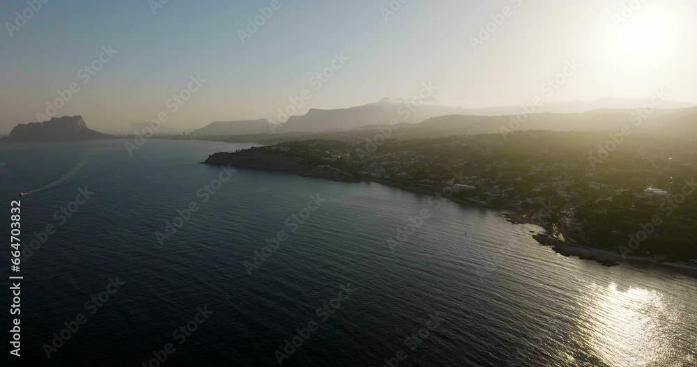 Drone Shot As Sun Sets Over Mediterranean Coast In Summer Soft Warm Light Drone Shot As Sun Sets Over Mediterranean Coast In Summer Soft Warm Light
