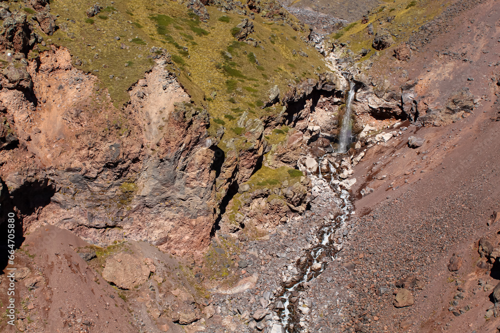The volcanic soil around the mountains and the river waterfall.