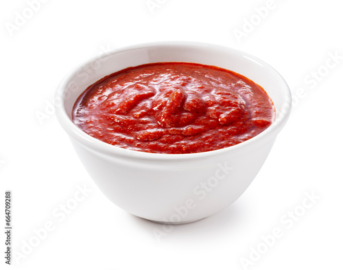 Tomato sauce in a bowl on a white background.