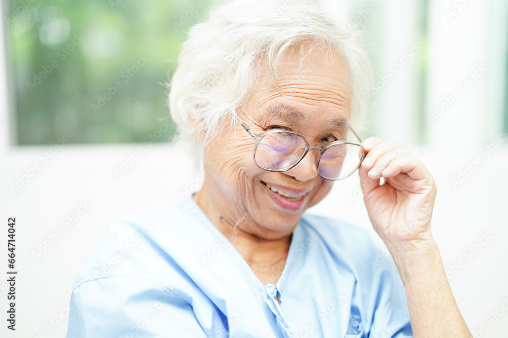 Asian senior woman wearing eyeglasses or vision glasses at home care service. Asian senior woman wearing eyeglasses or vision glasses at home care service.