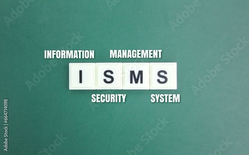 wooden cube with the letters ISMS or the word Information Security Management System. safety management concept photo