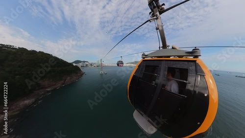 Cable car crossing above the ocean in Busan, offering a scenic view of the coastline and open sea