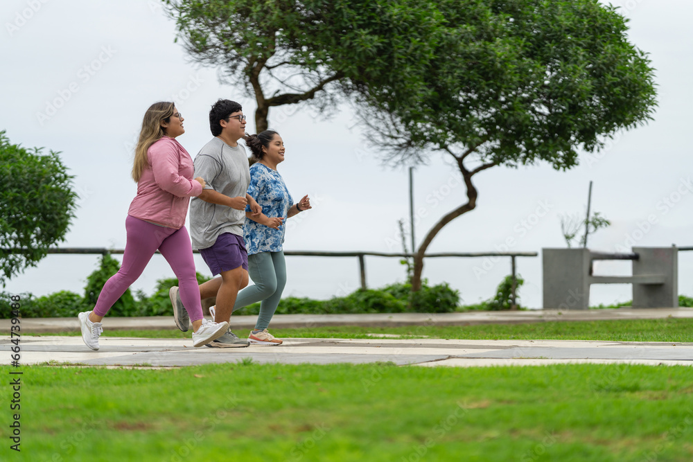 Side view of three fat people running along a path Side view of three fat people running along a path