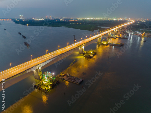 Under construction Vinh Tuy bridge at twilight with illuminated light