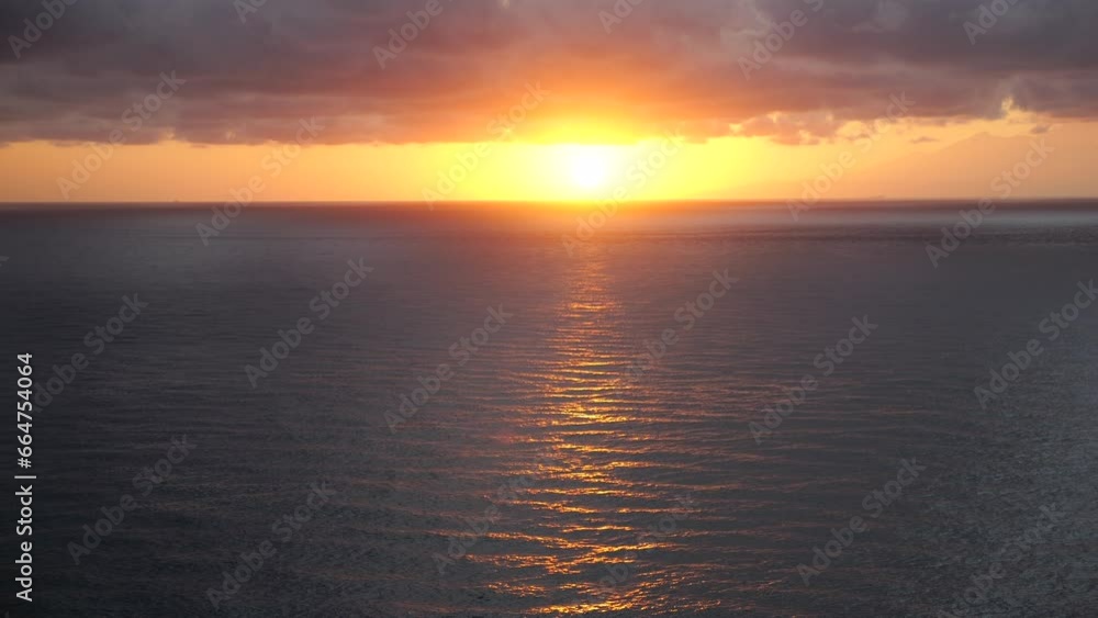 Aerial view of sunset horizon over ocean. Cinematic top view from mountain to beautiful evening sunset in sky over ocean. Sun path reflected in ocean surface Concept go camping in nature to see sunset Aerial view of sunset horizon over ocean. Cinematic top view from mountain to beautiful evening sunset in sky over ocean. Sun path reflected in ocean surface Concept go camping in nature to see sunset