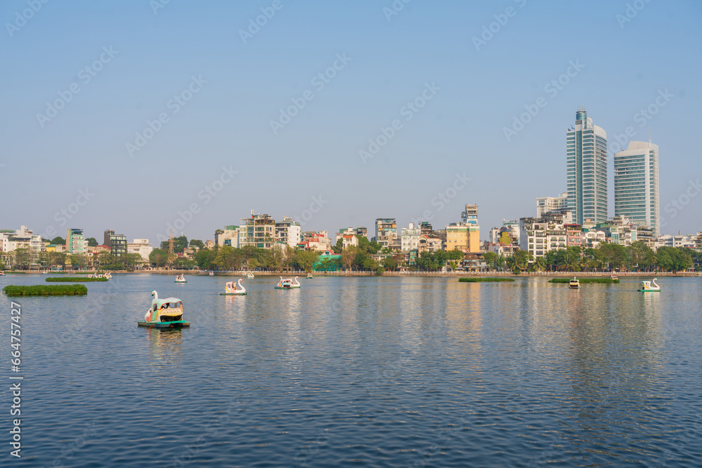 Hanoi skyline cityscape in Truc Bach lake with lake and city buildings Hanoi skyline cityscape in Truc Bach lake with lake and city buildings
