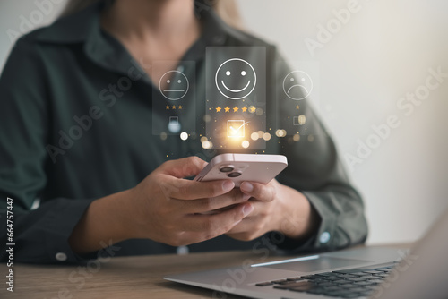 Wallpaper Mural customer satisfaction survey concept businesswoman use smartphone Touch the happy smiley icon. Satisfied. 5 stars. Service experience rating. online application Satisfaction Review best quality. Torontodigital.ca