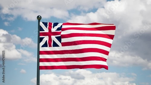 Grand union flag flutters in the wind. Historycal 1775  USA flag on cloudy background.