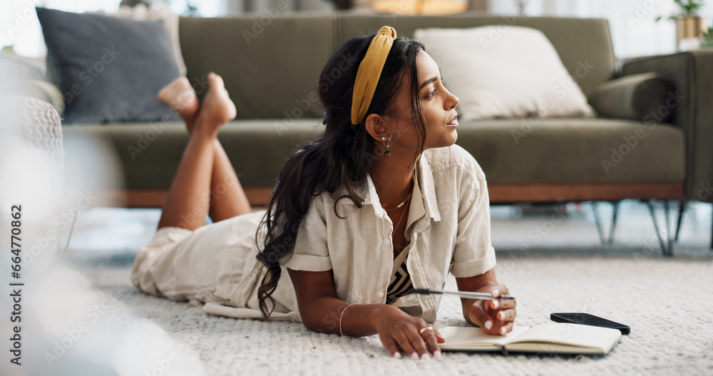 © N Felix/peopleimages.com - Thinking, writing in book and woman on floor in living room at home for creative idea, problem solving or planning vision. Serious, inspiration and Indian person with journal for notes, list or study © N Felix/peopleimages.com - Thinking, writing in book and woman on floor in living room at home for creative idea, problem solving or planning vision. Serious, inspiration and Indian person with journal for notes, list or study