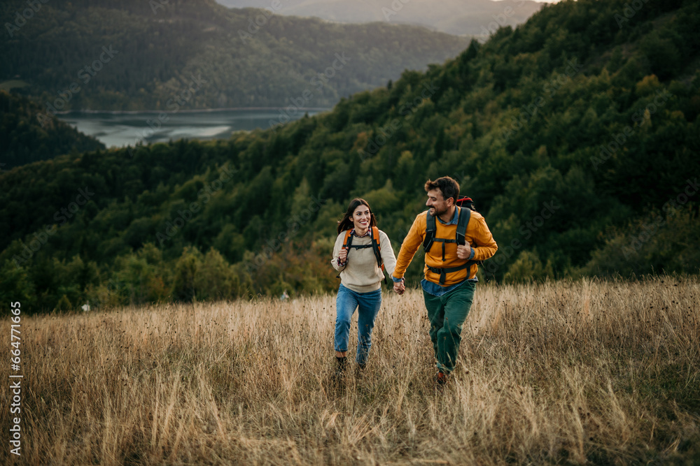 A heartwarming capture a loving couple, arms entwined, as they tenderly pack their backpacks after an exhilarating day of camping A heartwarming capture a loving couple, arms entwined, as they tenderly pack their backpacks after an exhilarating day of camping