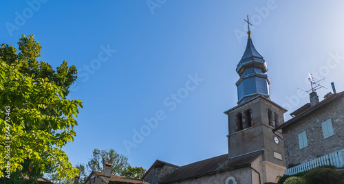 The Saint Pancrace church and its magnificent bell tower, and the marina, in the medieval village of Yvoire, in Haute Savoie, France photo