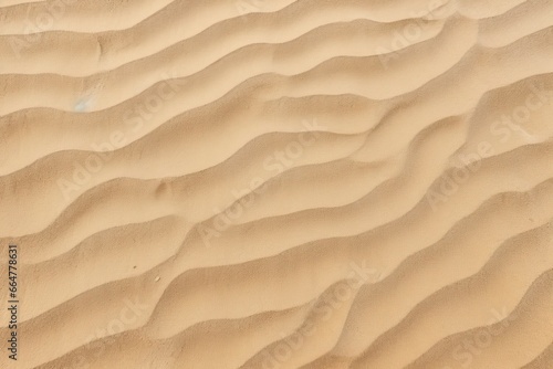 Closeup of sand pattern of a beach in the summer. © MstSanta