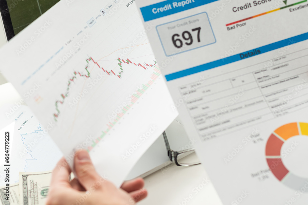 cropped view of man holding paper with credit report letters near laptop with blank screen cropped view of man holding paper with credit report letters near laptop with blank screen