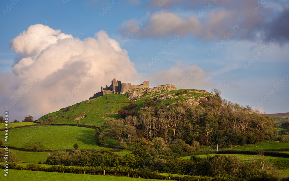 The dramatic castle ruins of Carrag Cennen located on top of a rocky hill in the Carmarthenshire countryside Wales UK