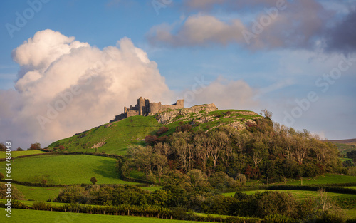 The dramatic castle ruins of Carrag Cennen located on top of a rocky hill in the Carmarthenshire countryside Wales UK photo