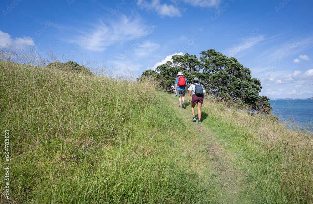 Couple hiking the Waiheke Island Coastal Track. Hauraki Gulf, New Zealand. Couple hiking the Waiheke Island Coastal Track. Hauraki Gulf, New Zealand.