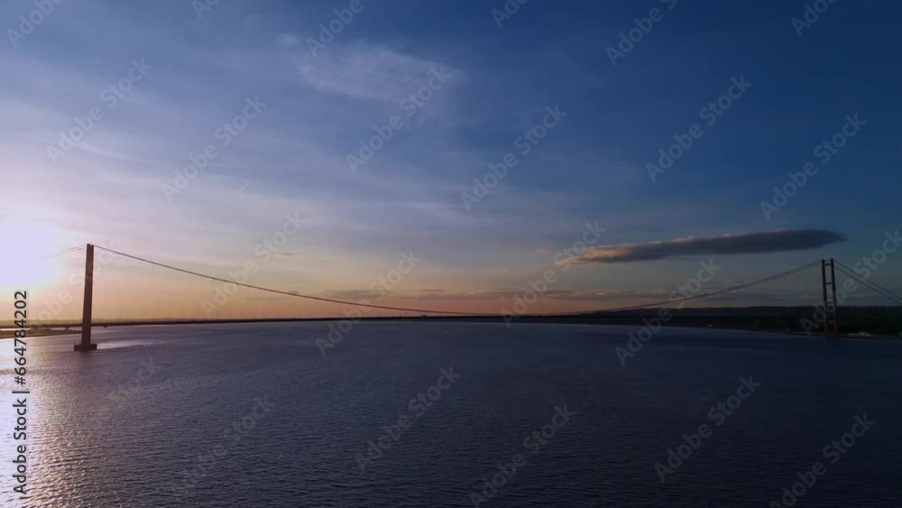 Twilight's magic: Humber Bridge, cars weaving their way in an aerial view. Twilight's magic: Humber Bridge, cars weaving their way in an aerial view.